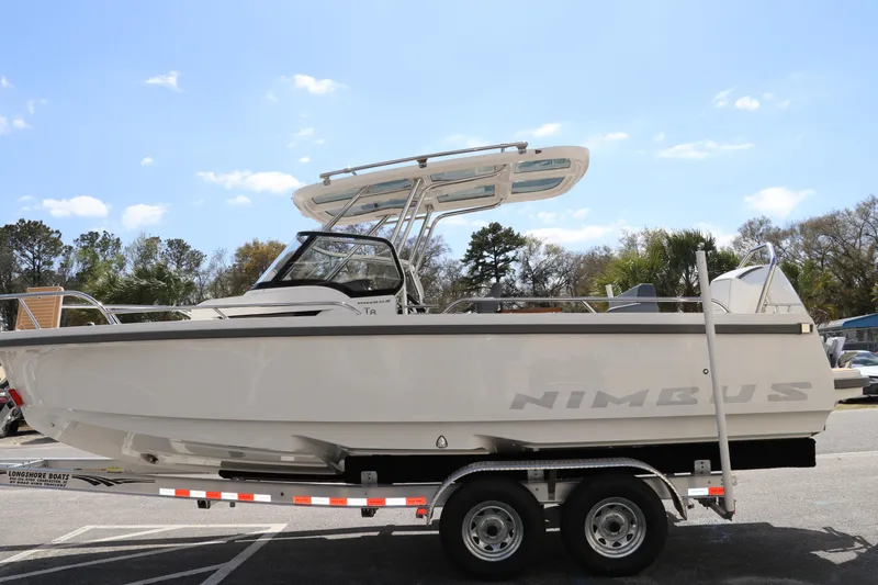 Slide: The Image of 2025 Nimbus Tender 8 boat on trailer under clear blue sky. - 1