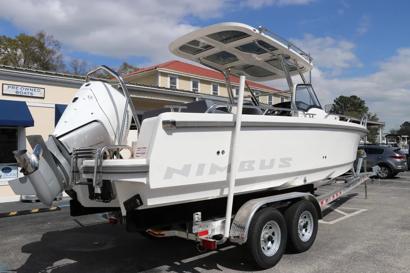 Slide: The Image of 2025 Nimbus Tender 8 boat on trailer, parked outdoors under a partly cloudy sky. - 10