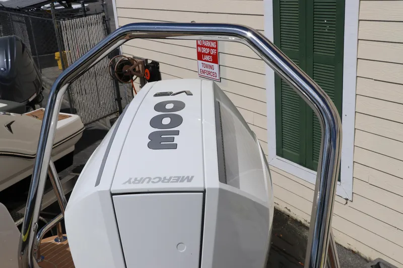 Slide: The Image of Outboard motor on Nimbus Tender 8, 2025 model, with a "No Parking" sign nearby. - 12