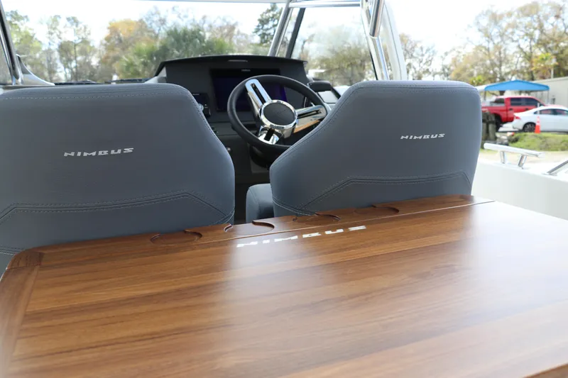 Slide: The Image of Interior view of 2025 Nimbus Tender 8 boat with wooden table and steering wheel. - 19