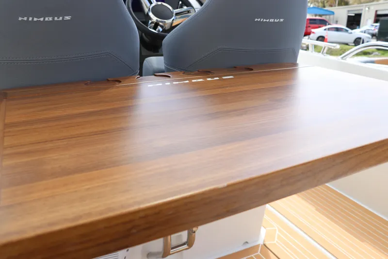 Slide: The Image of 2025 Nimbus Tender 8 boat interior with wooden table and branded seats. - 20