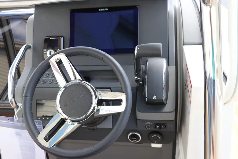 Slide: The Image of Steering console of 2025 Nimbus Tender 8 boat with modern controls and display. - 21