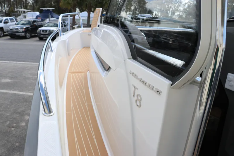 Slide: The Image of 2025 Nimbus Tender 8 boat interior with orange seating and modern dashboard. - 30