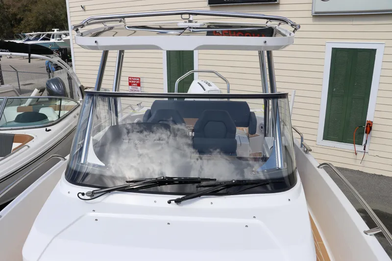 Slide: The Image of 2025 Nimbus Tender 8 boat, sleek design, docked with visible branding. - 34