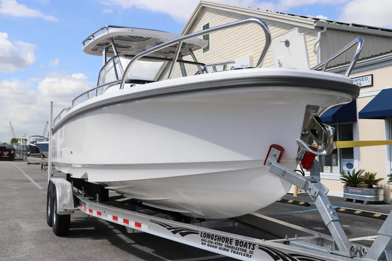 Slide: The Image of 2025 Nimbus Tender 8 boat on trailer, parked outdoors under a partly cloudy sky. - 5