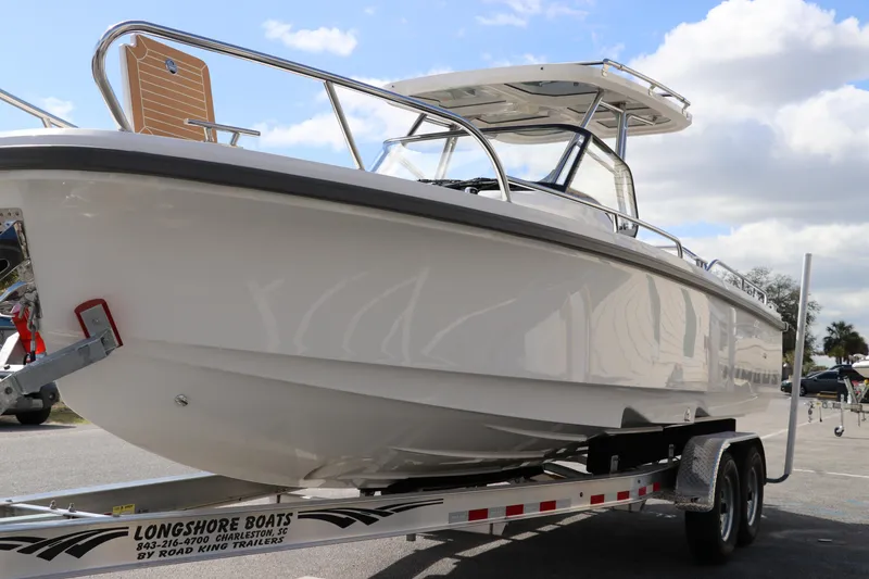 Slide: The Image of 2025 Nimbus Tender 8 boat on trailer under a partly cloudy sky. - 6