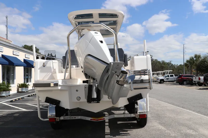 Slide: The Image of 2025 Nimbus Tender 8 boat with powerful outboard motor, parked outdoors under a clear sky. - 7