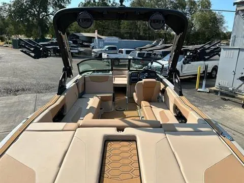 Slide: The Image of 2025 MasterCraft NXT23 boat interior with tan seating and modern dashboard. - 4