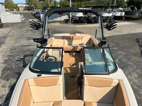 Slide: The Image of 2025 MasterCraft NXT23 boat with tan interior and open deck layout. - 9