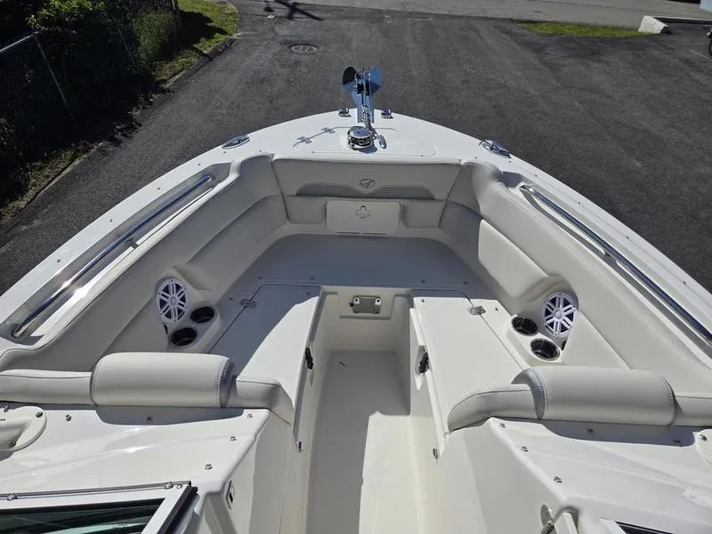 Slide: The Image of 2025 Sailfish 245 DC boat interior with cushioned seating and cup holders. - 13