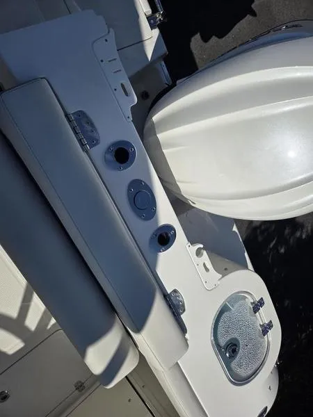 Slide: The Image of 2025 Sailfish 245 DC boat interior with seating and storage compartments. - 5