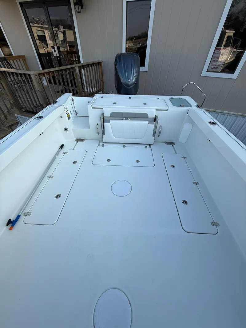 Slide: The Image of 2025 Parker 2420 Sport Cabin boat deck, spacious and clean, with modern design features. - 4