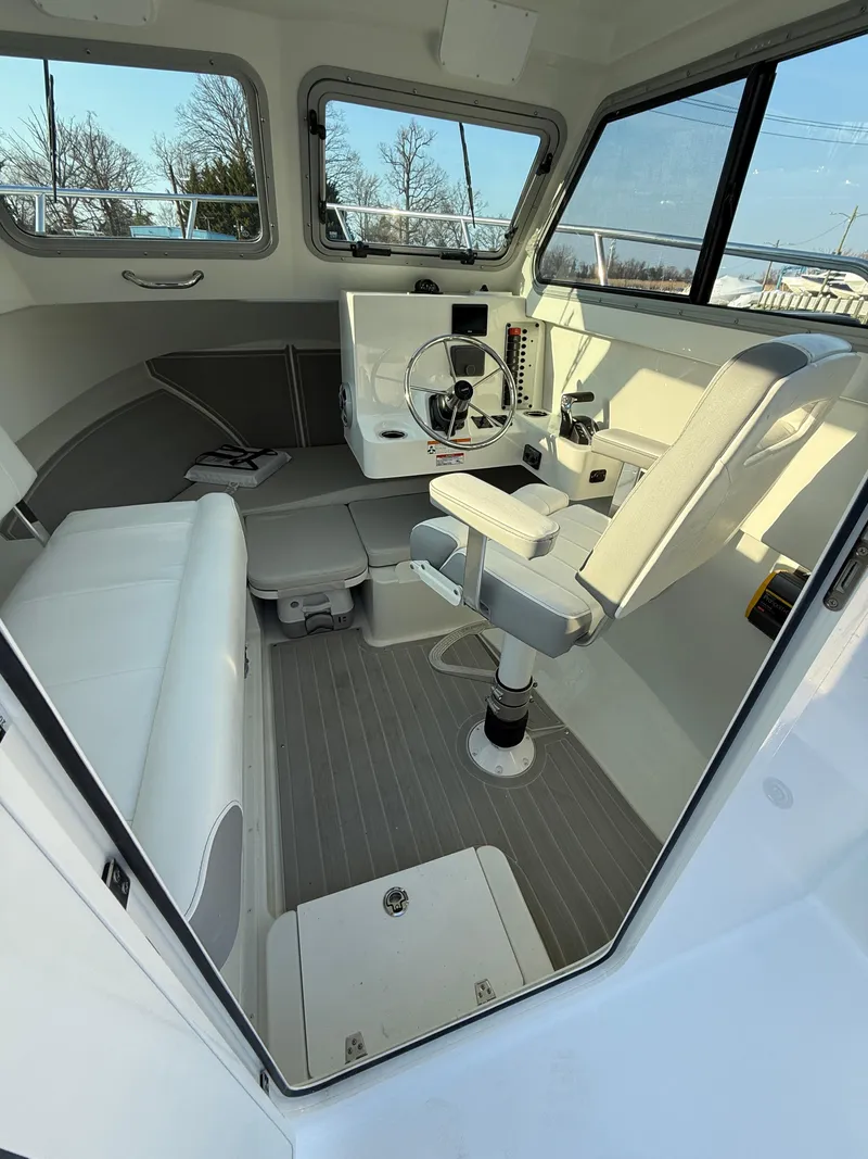 Slide: The Image of 2025 Parker 2420 Sport Cabin interior with modern seating and control panel. - 5