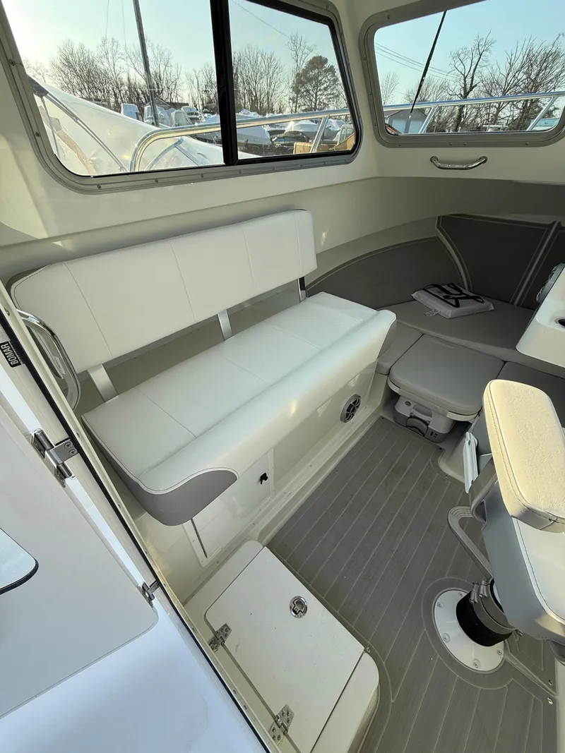 Slide: The Image of 2025 Parker 2420 Sport Cabin interior with seating and storage. - 6