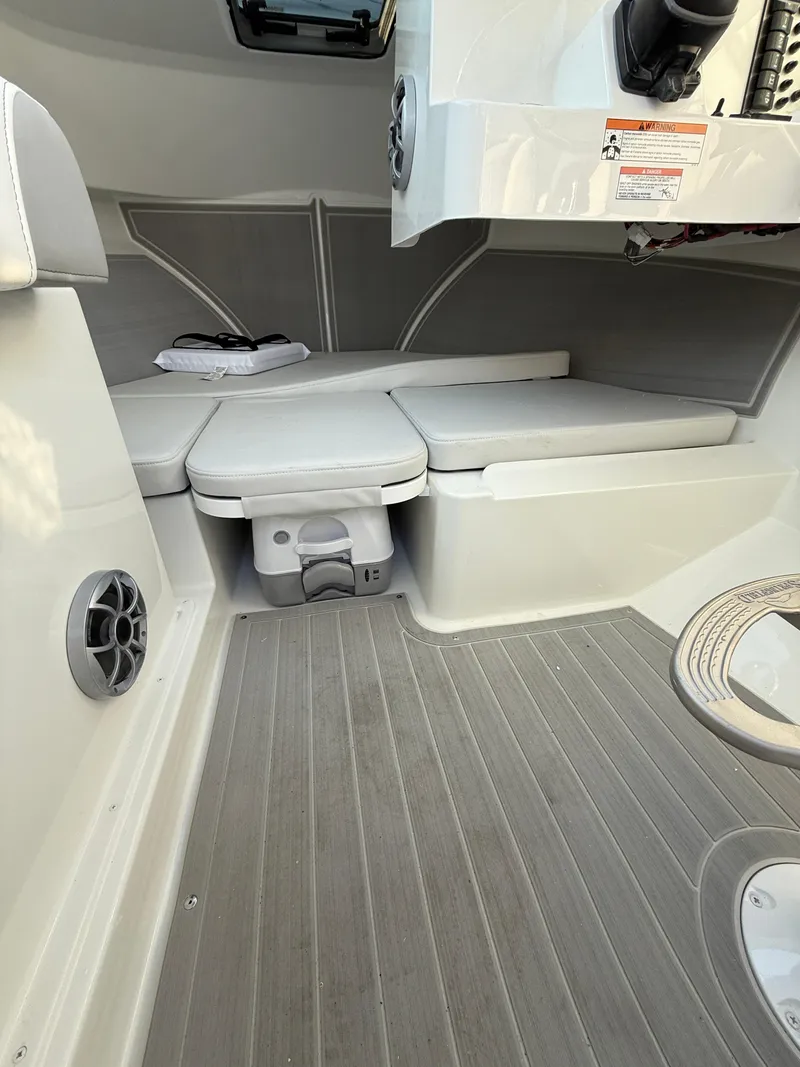 Slide: The Image of 2025 Parker 2420 Sport Cabin interior with cushioned seating and modern design. - 7