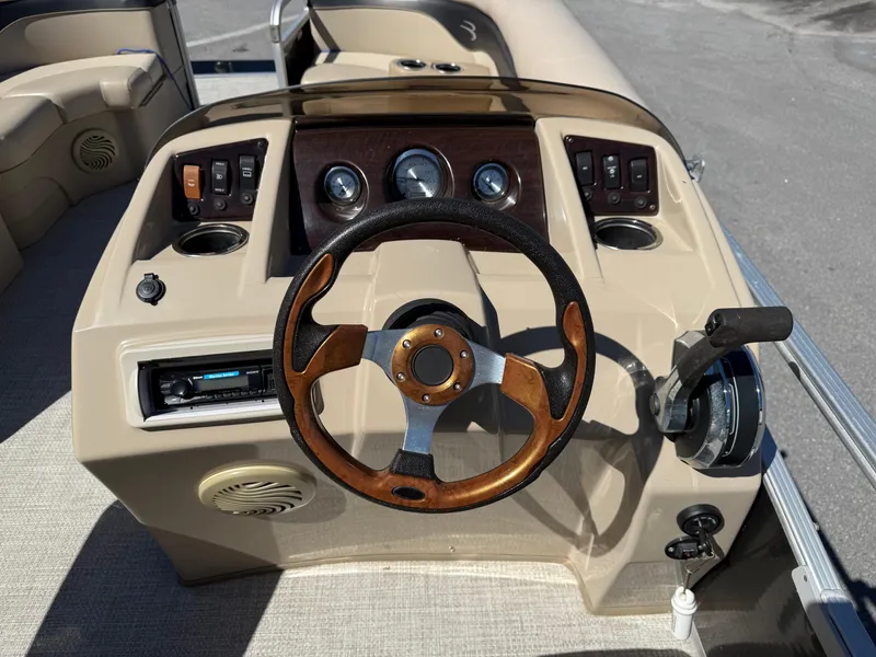 Slide: The Image of 2015 Bennington SLMX boat dashboard with steering wheel and control panel. - 10