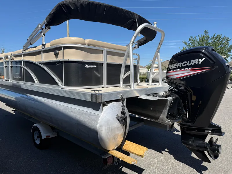 Slide: The Image of 2015 Bennington SLMX pontoon boat with Mercury outboard motor on a trailer. - 13