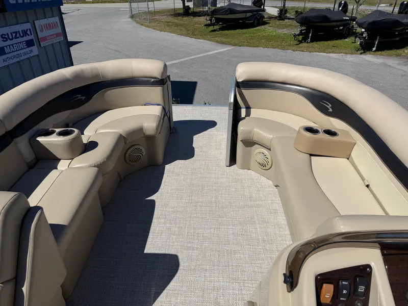 Slide: The Image of 2015 Bennington SLMX boat interior with beige seating and cup holders. - 7