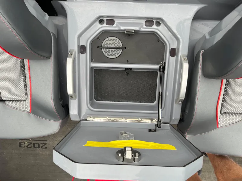 Slide: The Image of 2023 Ranger Z521R boat storage compartment with open lid, showcasing interior details. - 11