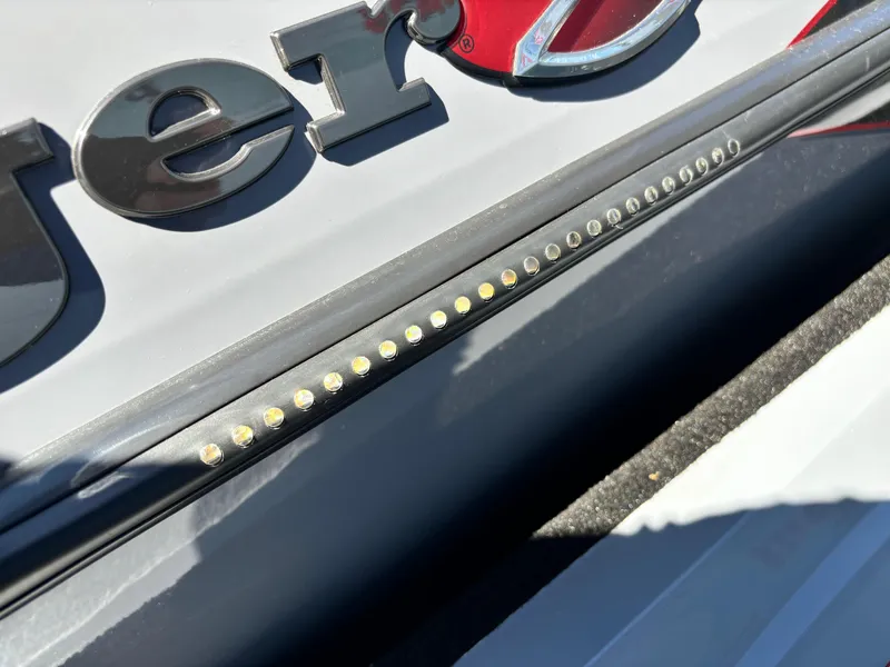 Slide: The Image of 2023 Ranger Z521R boat detail with LED lights and logo. - 13