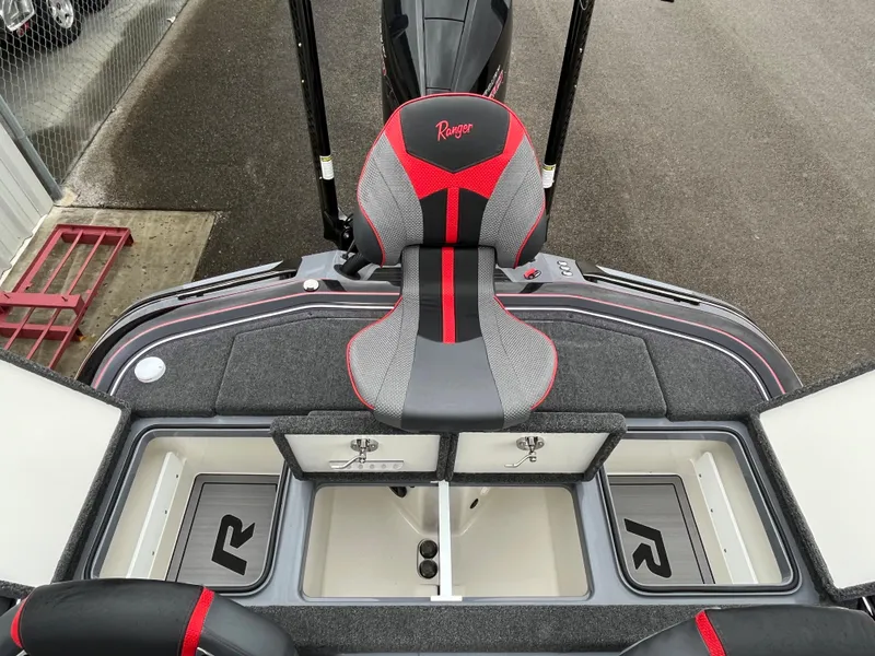 Slide: The Image of 2023 Ranger Z521R boat interior with red and gray seating and storage compartments. - 14