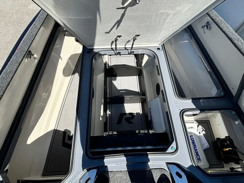 Slide: The Image of 2023 Ranger Z521R boat storage compartment with Lowrance equipment and organized interior layout. - 7