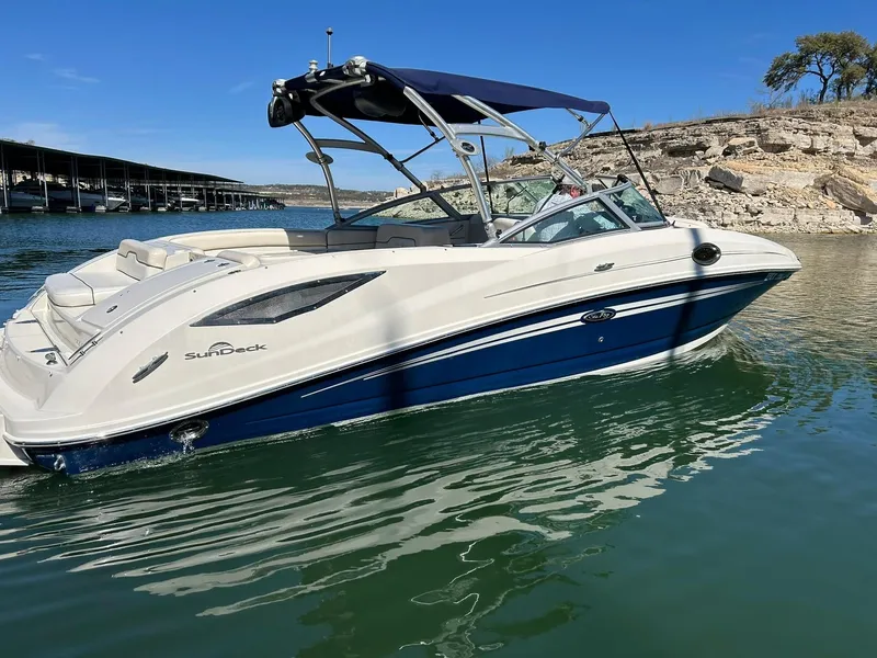 Slide: The Image of 2008 Sea Ray 290 Sundeck boat on calm water, featuring a sleek design and blue accents. - 17