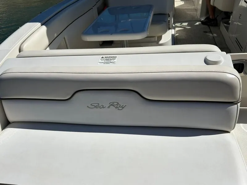 Slide: The Image of 2008 Sea Ray 290 Sundeck interior with white seating and table. - 22