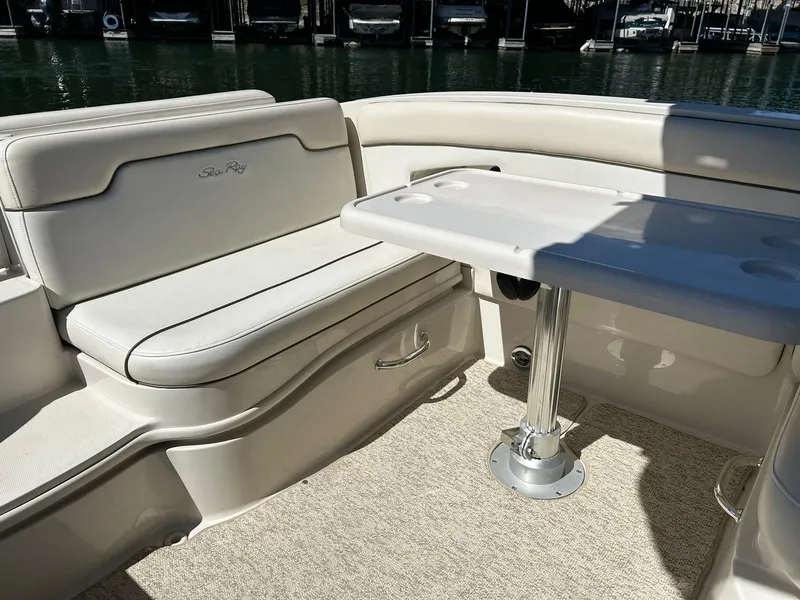 Slide: The Image of 2008 Sea Ray 290 Sundeck interior with seating and table, docked at marina. - 27