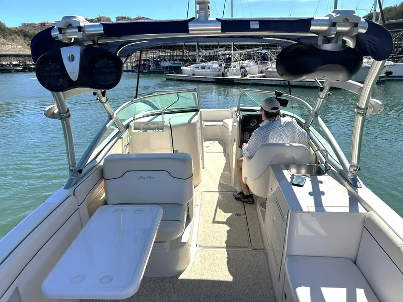 Slide: The Image of 2008 Sea Ray 290 Sundeck boat interior with seating and helm, docked in marina. - 3