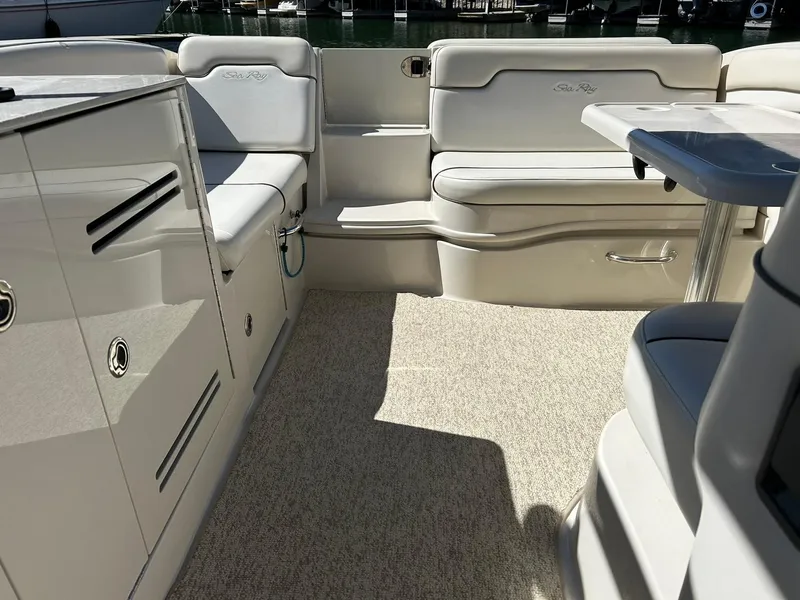 Slide: The Image of 2008 Sea Ray 290 Sundeck interior with cushioned seating and sleek cabinetry. - 30