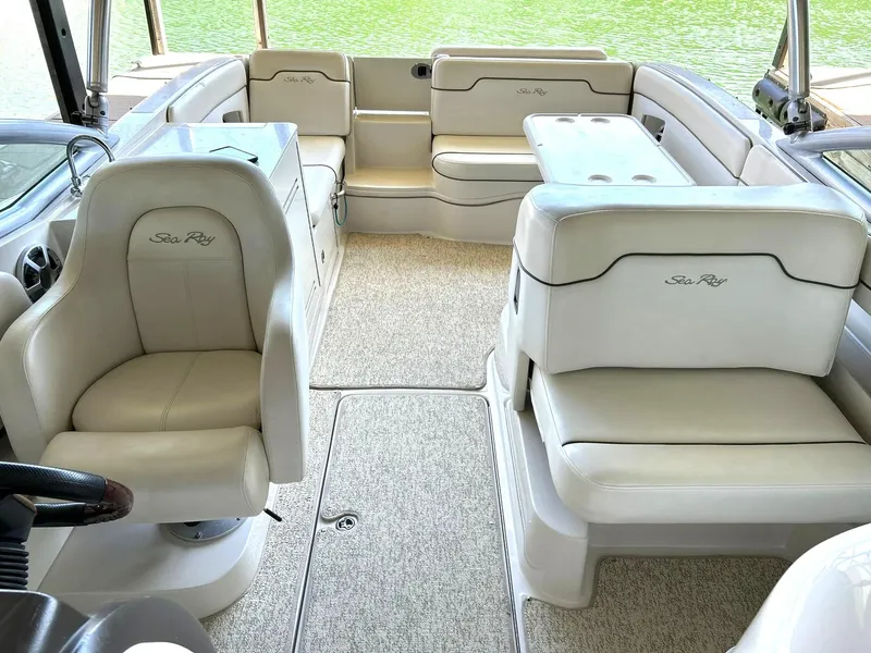 Slide: The Image of 2008 Sea Ray 290 Sundeck interior with beige seating and carpeted floor. - 32
