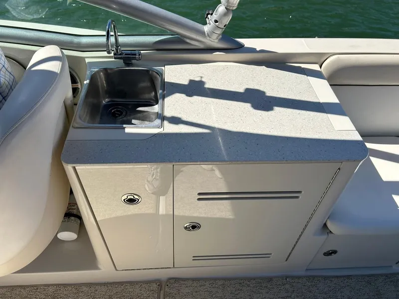 Slide: The Image of 2008 Sea Ray 290 Sundeck boat interior with sink and storage cabinet. - 33