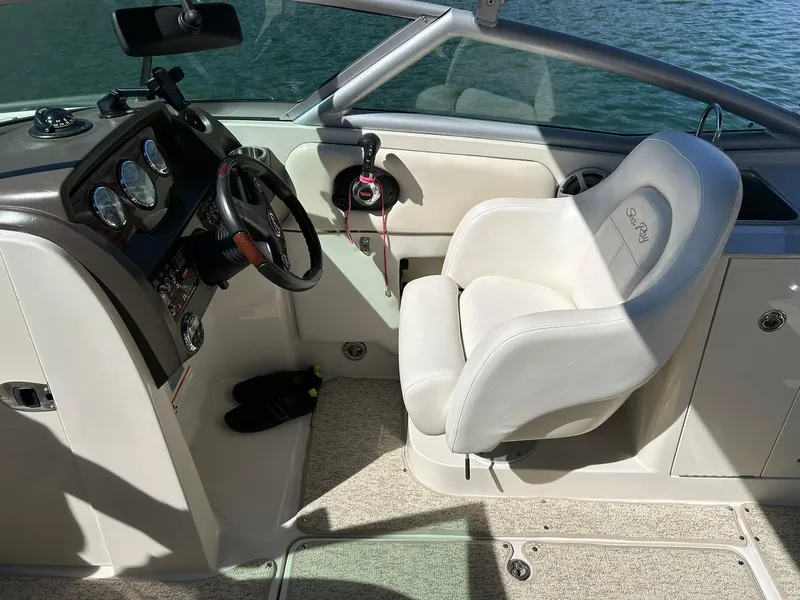 Slide: The Image of 2008 Sea Ray 290 Sundeck cockpit with steering wheel and comfortable seating. - 37