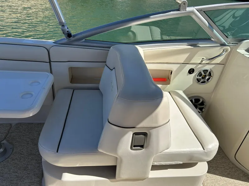 Slide: The Image of 2008 Sea Ray 290 Sundeck interior with beige seating and table, featuring a sleek design. - 41