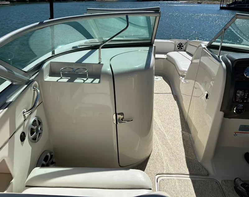 Slide: The Image of 2008 Sea Ray 290 Sundeck interior with seating and helm, overlooking water. - 42