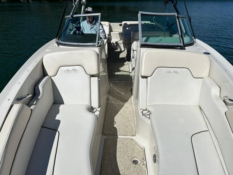 Slide: The Image of 2008 Sea Ray 290 Sundeck boat interior with white seating and open deck layout. - 45