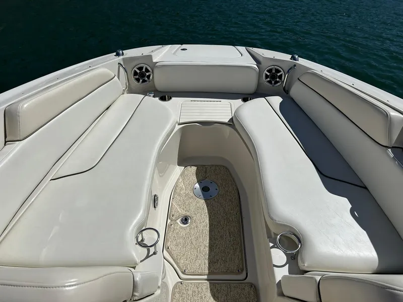Slide: The Image of 2008 Sea Ray 290 Sundeck boat interior with cushioned seating and cup holders. - 46