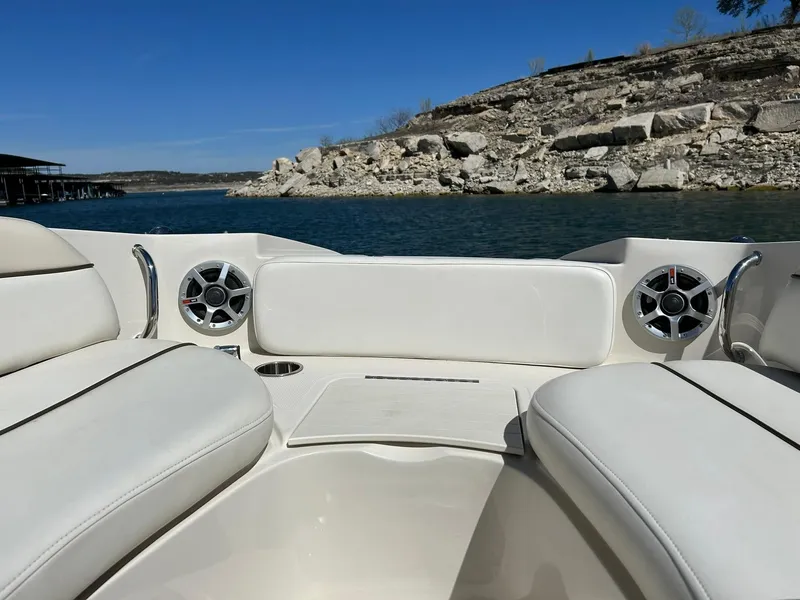 Slide: The Image of 2008 Sea Ray 290 Sundeck boat interior with white seating, speakers, and scenic lake view. - 49