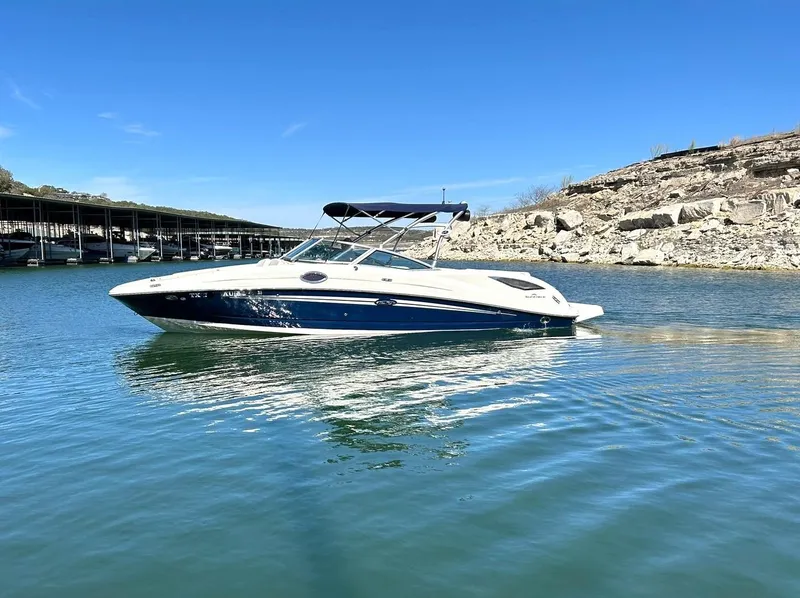 Slide: The Image of 2008 Sea Ray 290 Sundeck boat on calm water, clear blue sky background. - 7