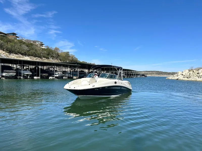 Slide: The Image of 2008 Sea Ray 290 Sundeck boat on a calm lake under clear blue skies. - 9