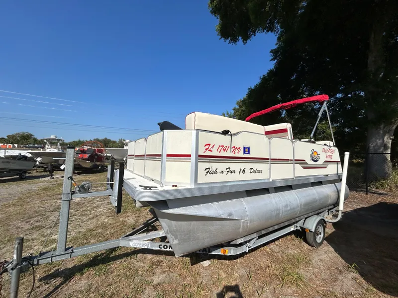 The Image of 2008 Fiesta Fish n Fun 16 Deluxe pontoon boat on trailer, parked outdoors. - 1