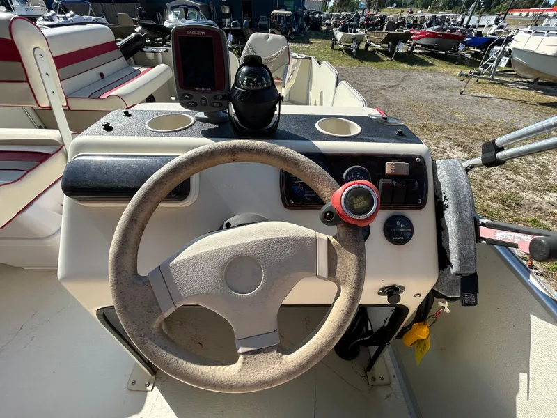 Slide: The Image of 2008 Fiesta Fish n Fun 16 Deluxe boat dashboard with steering wheel and controls. - 11