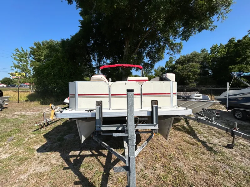 Slide: The Image of 2008 Fiesta Fish n Fun 16 Deluxe pontoon boat on trailer, parked outdoors. - 3