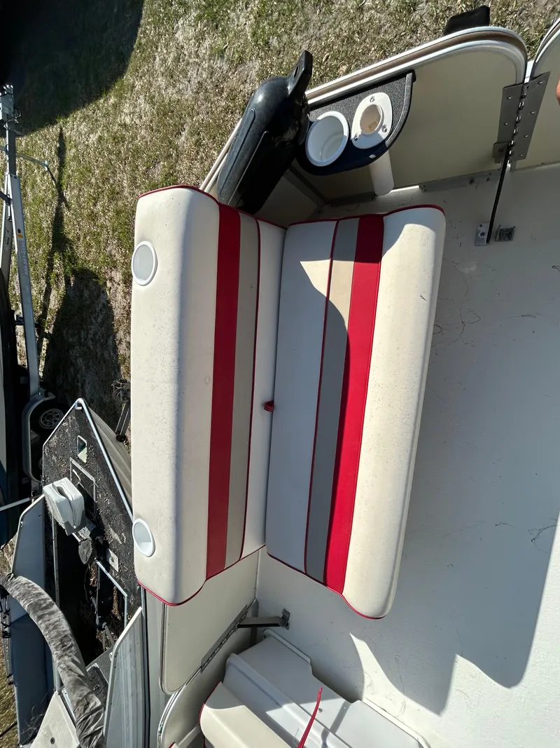 Slide: The Image of 2008 Fiesta Fish n Fun 16 Deluxe boat interior with red-striped seating. - 7