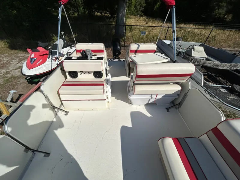 Slide: The Image of 2008 Fiesta Fish n Fun 16 Deluxe boat interior with striped seating and steering console. - 8