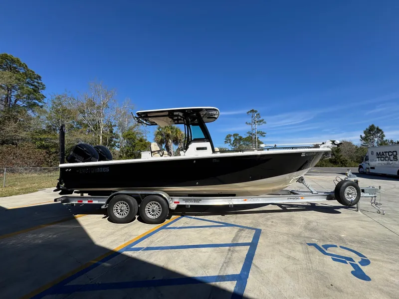 Slide: The Image of 2017 Everglades 273 Center Console boat on trailer in parking lot, clear sky background. - 13