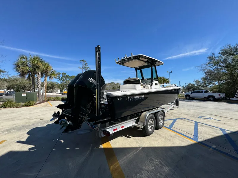 Slide: The Image of 2017 Everglades 273 Center Console boat on trailer in sunny parking lot. - 17