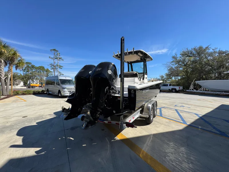 Slide: The Image of 2017 Everglades 273 Center Console boat on trailer, parked outdoors under clear blue sky. - 18