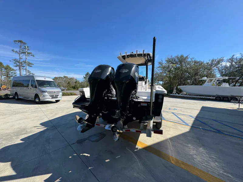 Slide: The Image of 2017 Everglades 273 Center Console boat with dual engines in a sunny outdoor setting. - 19